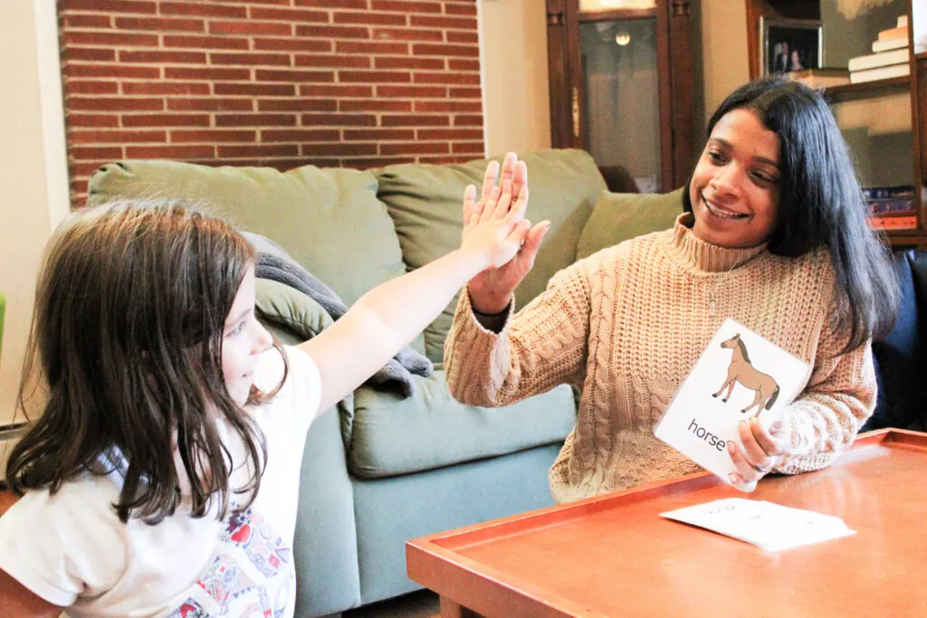 A Personal Growth Services team member giving a young girl a high five